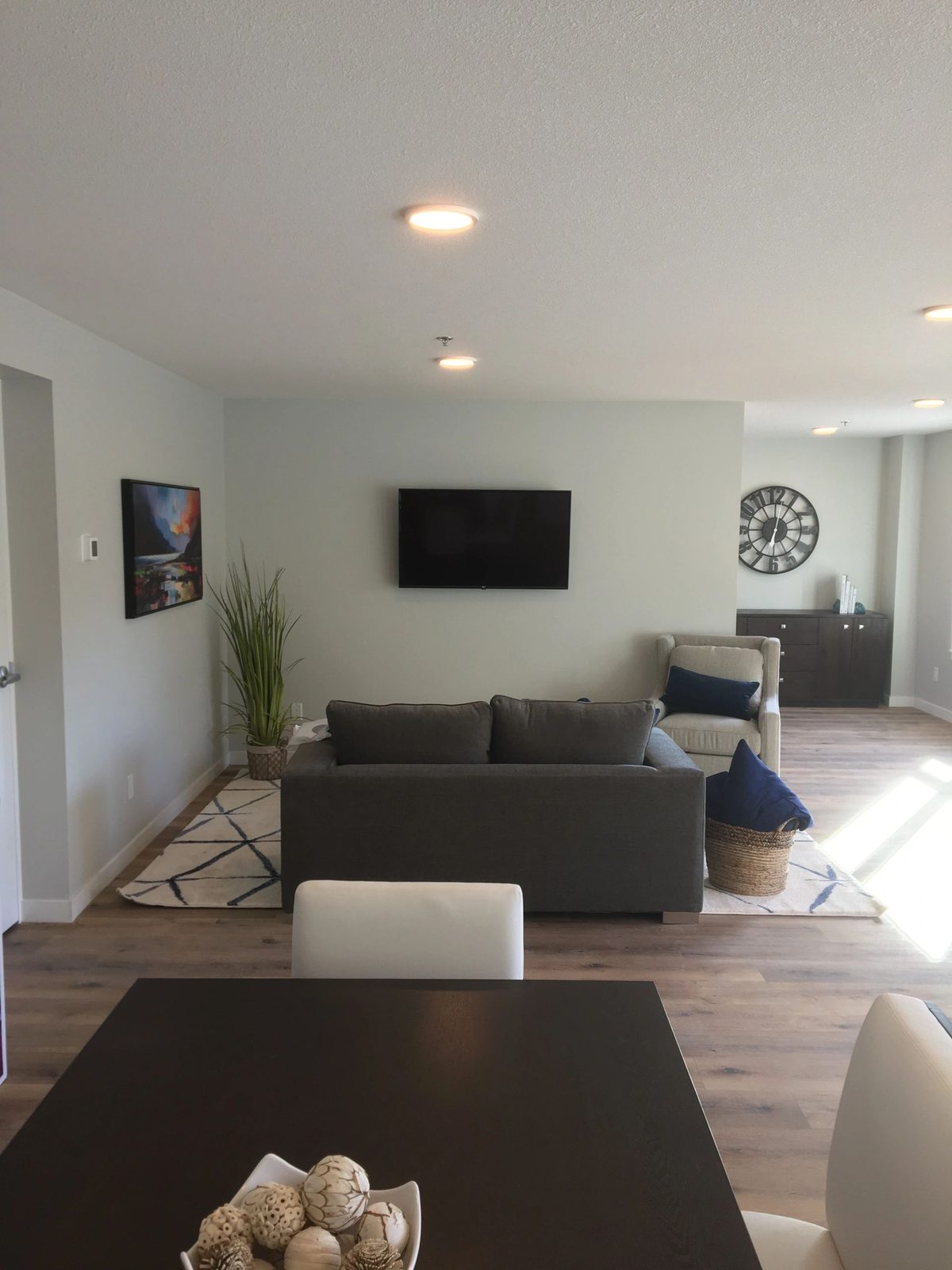 TV mounted on a grey feature wall in a living room