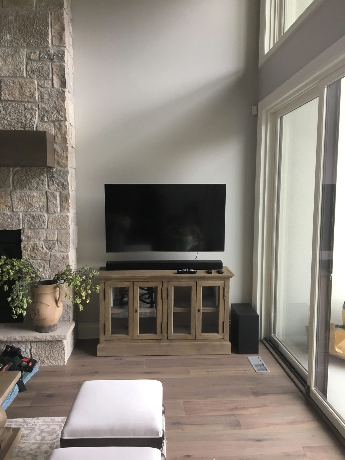 Stone feature wall with mounted TV above a media cabinet