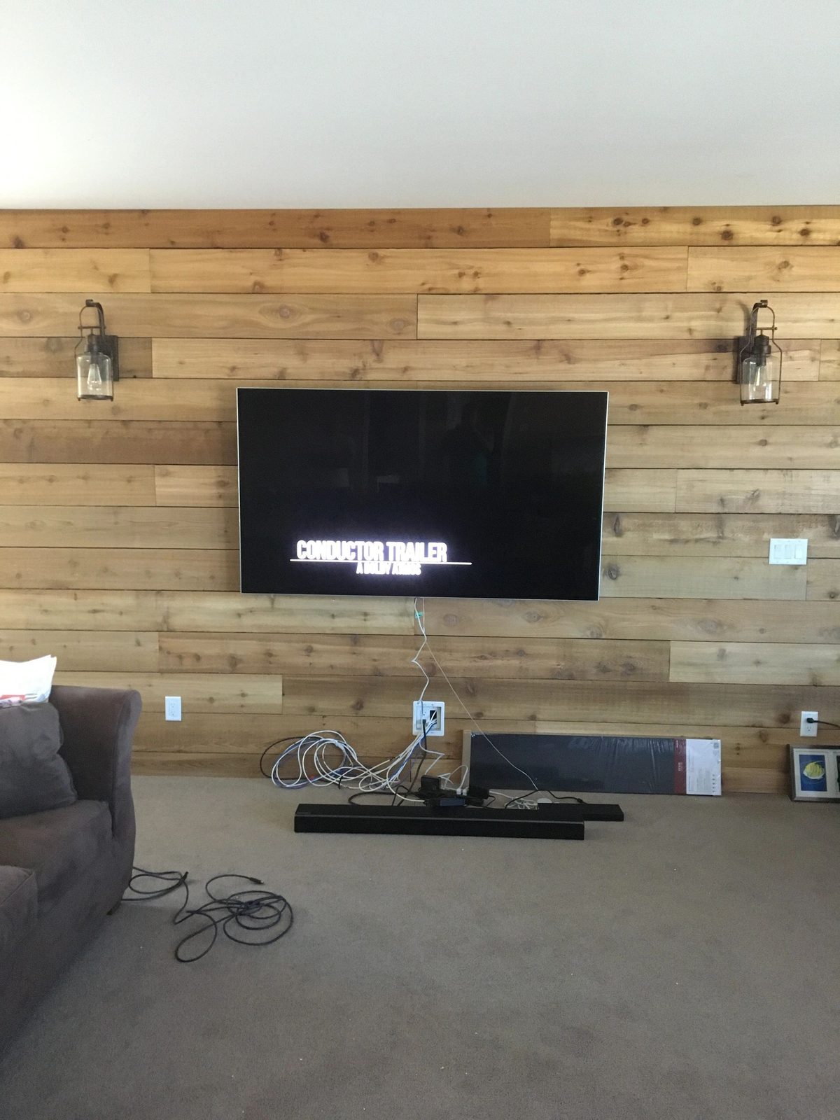 TV mounted on a reclaimed timber plank accent wall