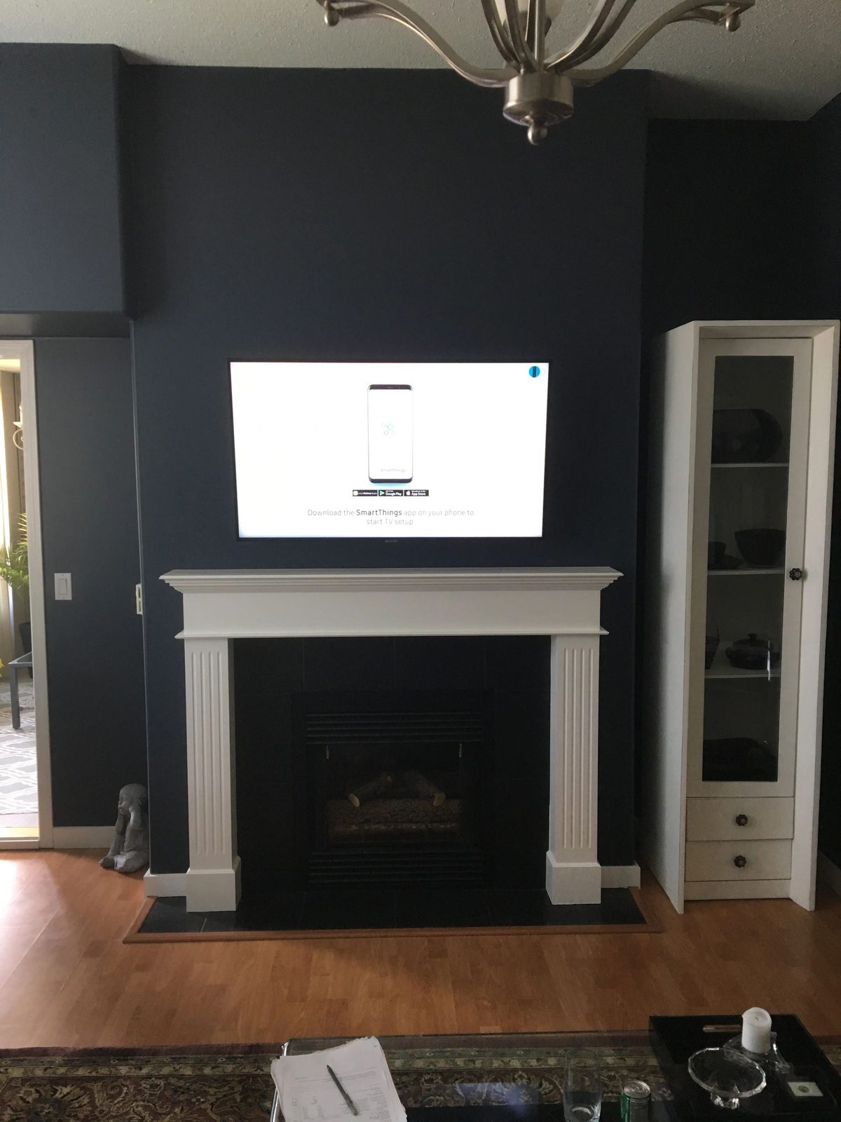 TV mounted above a white painted mantle