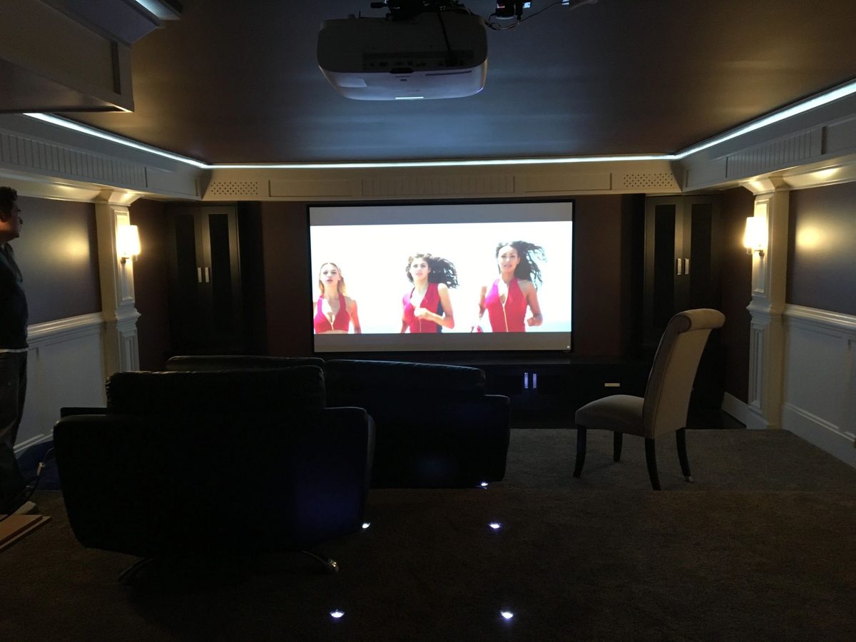 Home theatre with a projector screen and tower speakers