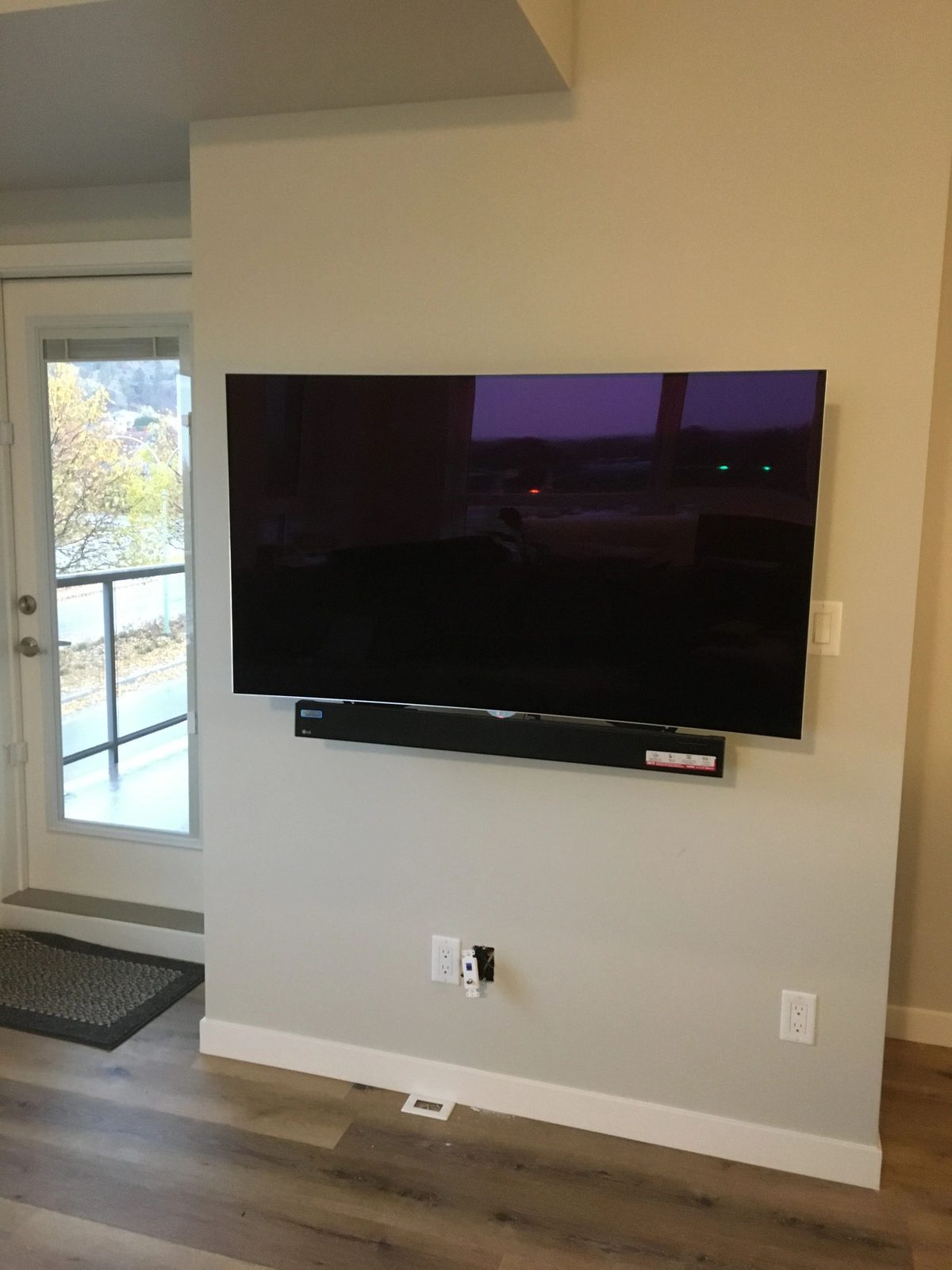 TV and soundbar mounted in a lakeview living room