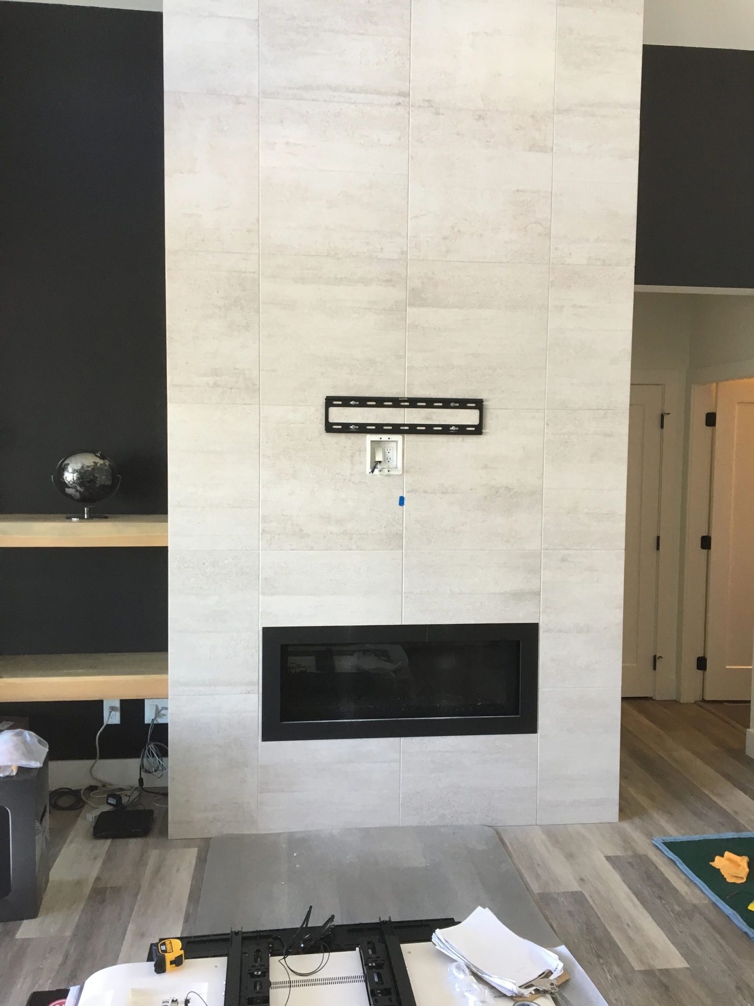Wall mount and recessed plate set on the bare porcelain-tile chimney breast before the TV went on