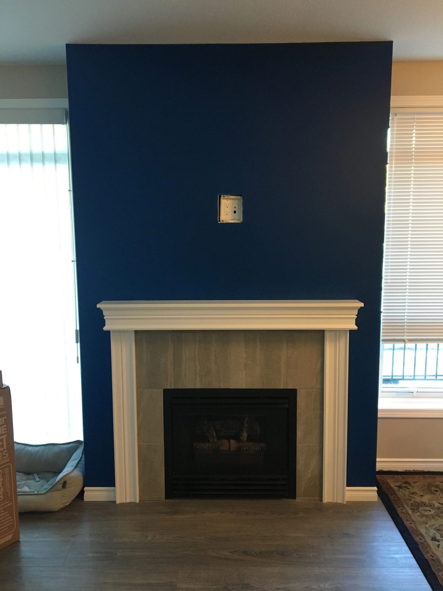 Blank navy feature wall above a fireplace before installation