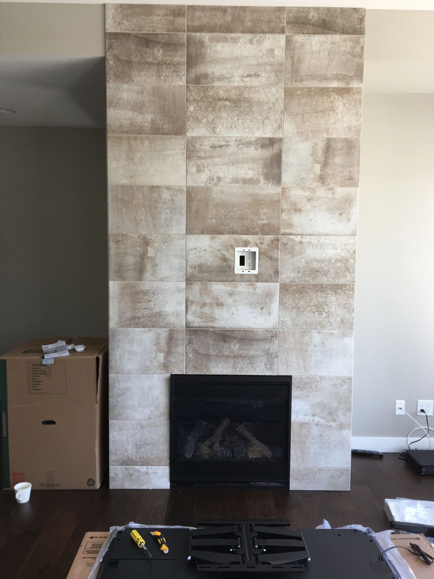 Bare travertine stone feature wall before the TV was mounted